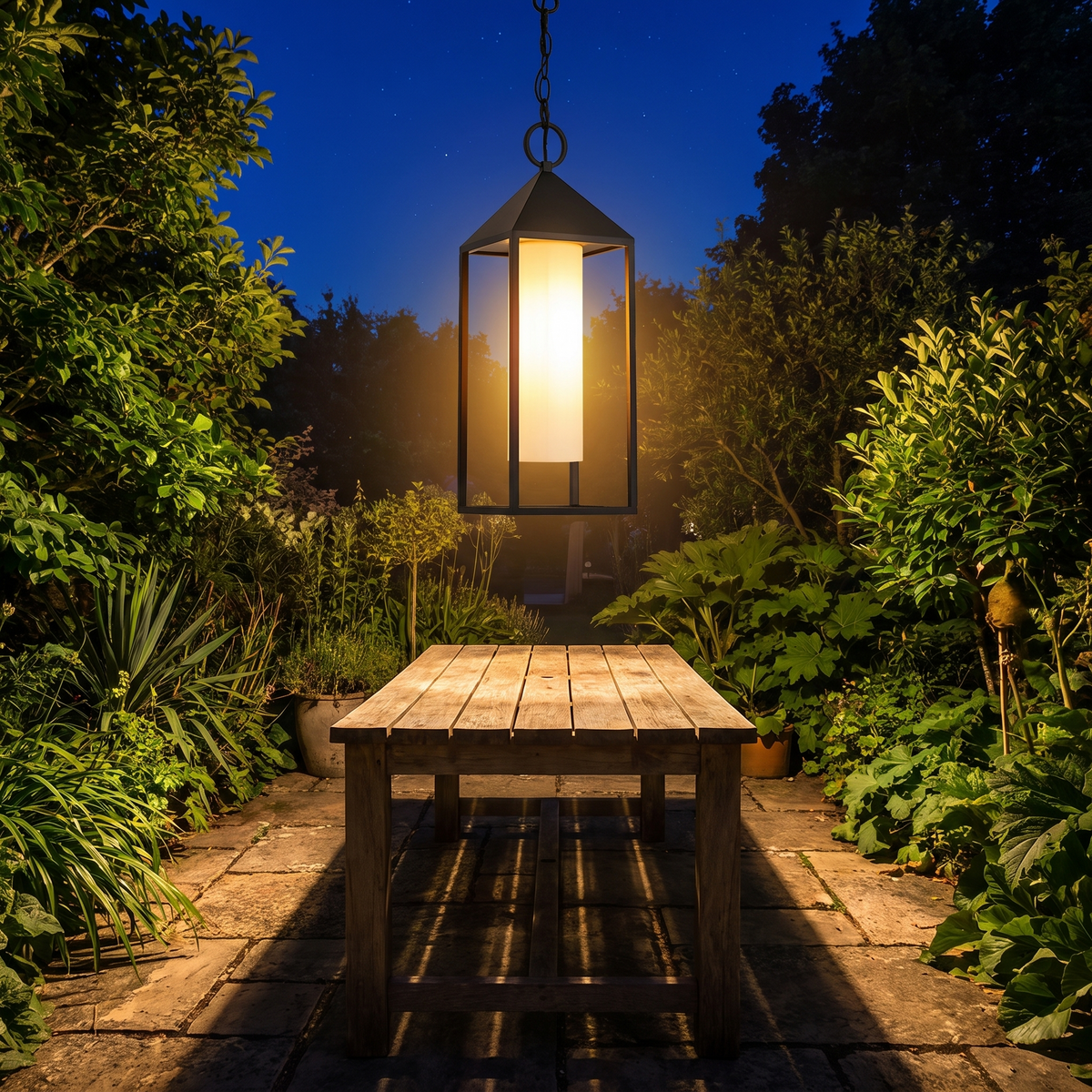 Lantera lantern over a garden dining table at night