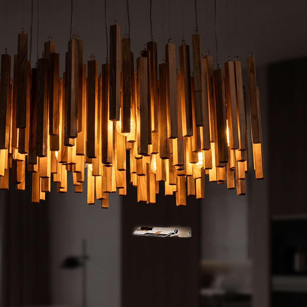 Kindra chandelier lit wood sticks close up
