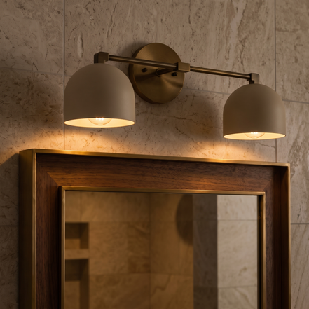 Caldera brushed brass dome vanity wall light above a mirror