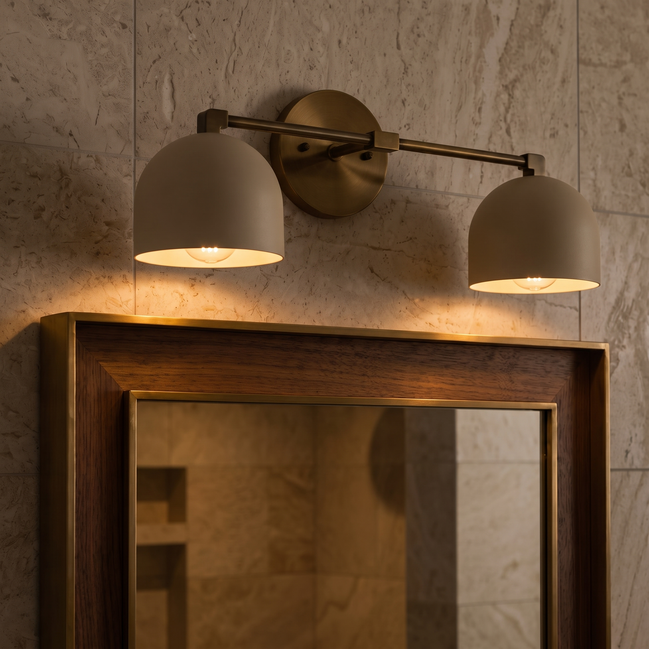Caldera brushed brass dome vanity wall light above a mirror
