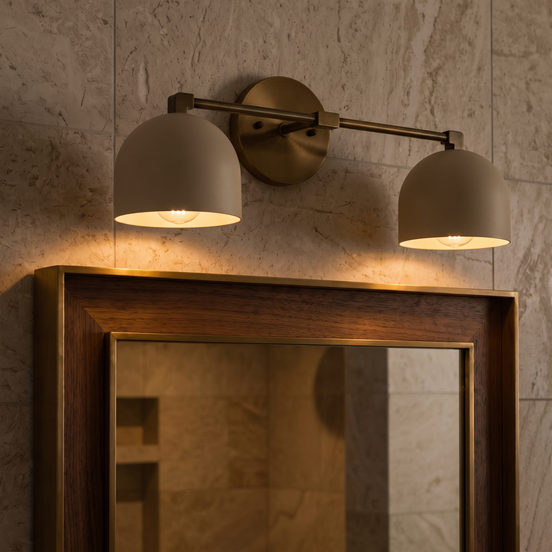 Caldera brushed brass dome vanity wall light above a mirror