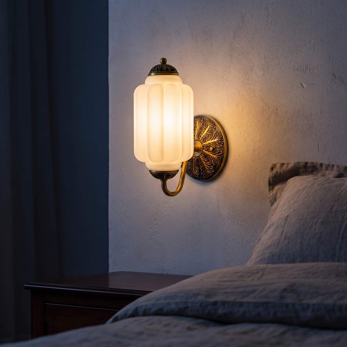 Lisette frosted milk glass wall sconce beside a bed