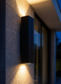 Axil up and down outdoor wall light on a stone entry