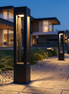 Monolyth LED bollard lights along a stone walkway